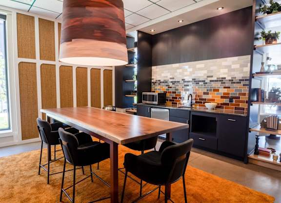 A modern kitchen with a dining table and chairs.