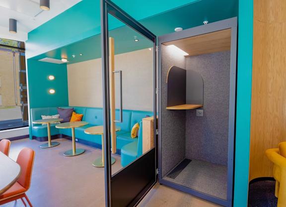 A room with a blue wall and a yellow chair.