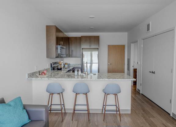A kitchen with a bar area and a couch.