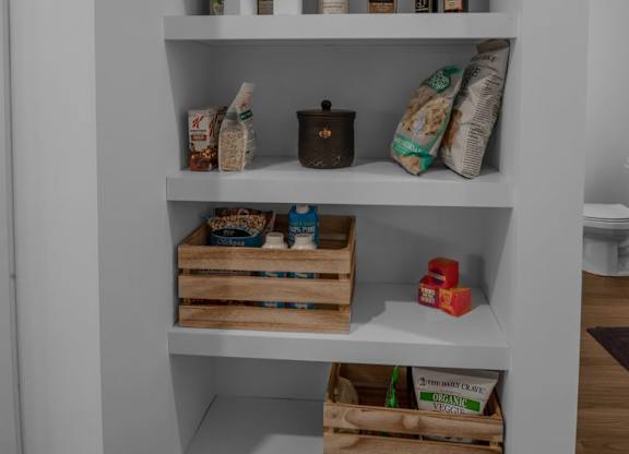 A white shelf with various items on it.