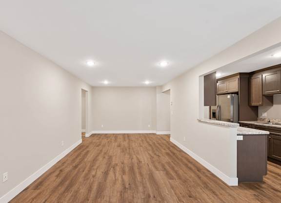 A kitchen area with wooden floors and a countertop.
