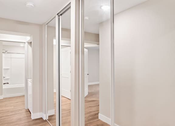 A white room with a mirror on the wall.