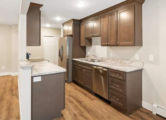 A kitchen with brown cabinets and a white island.