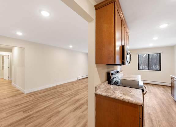 A kitchen with a wooden island and cabinets.