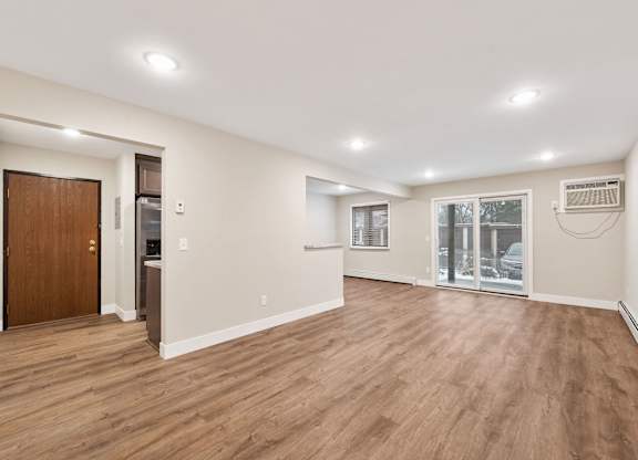 A room with wooden floors and white walls.