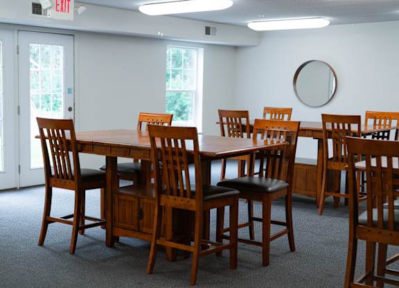 A conference room with a long table and chairs.