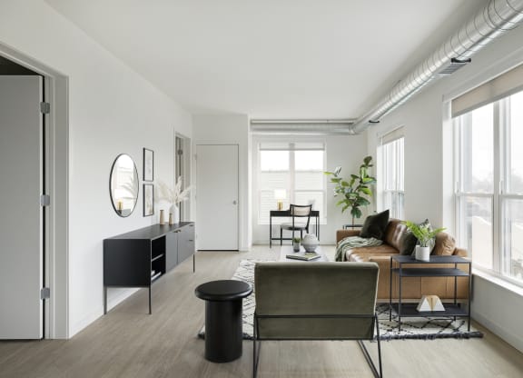 a living room with white walls and hardwood floors
