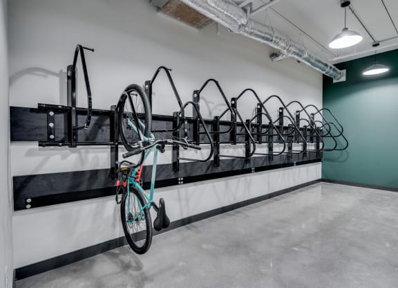 a row of bikes hanging on a wall in a room