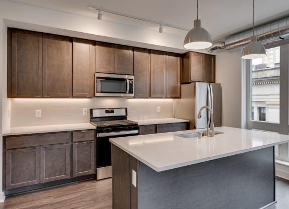 a kitchen with wooden cabinets and a white counter top