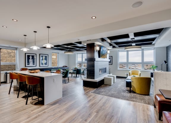 a living room and dining room with a fireplace and a table with chairs