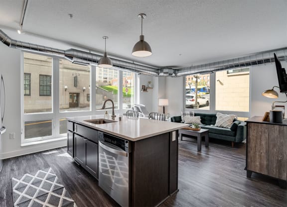 a kitchen and living room with a wall of windows