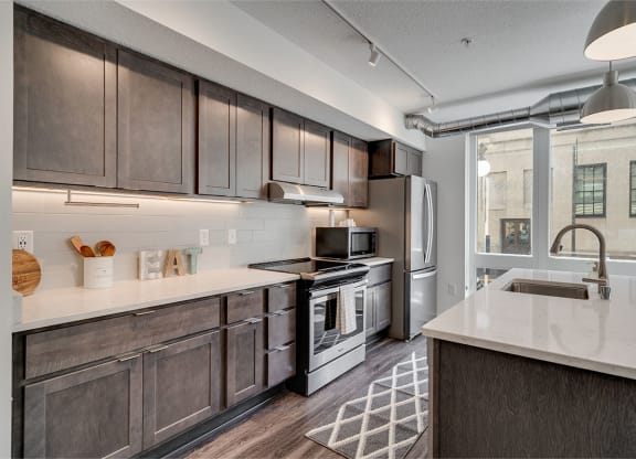 a kitchen with stainless steel appliances and wooden cabinets