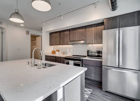 a large white kitchen with stainless steel appliances