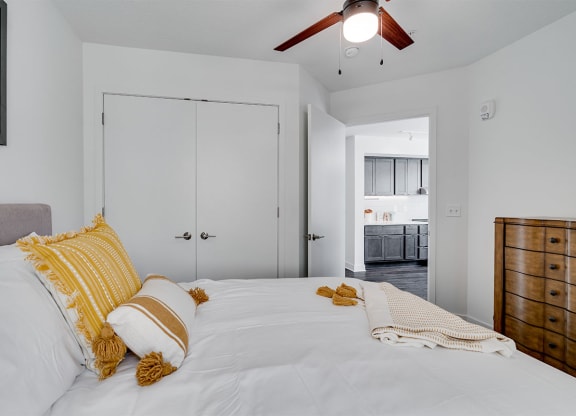 a bedroom with a large bed and a ceiling fan