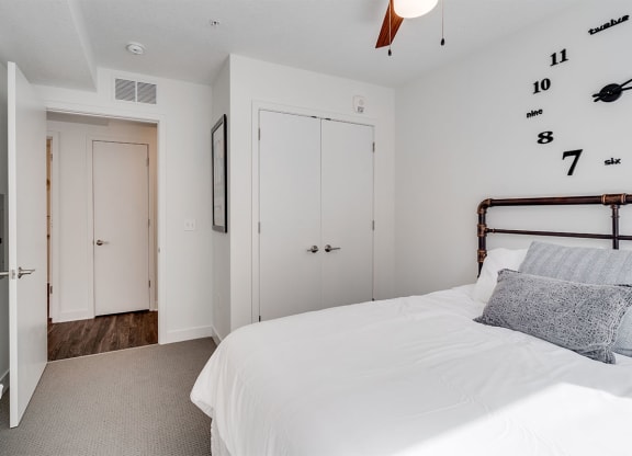 a bedroom with a bed and a door to a bathroom