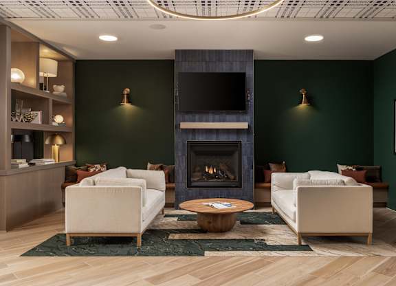 A living room with a fireplace and two chairs.