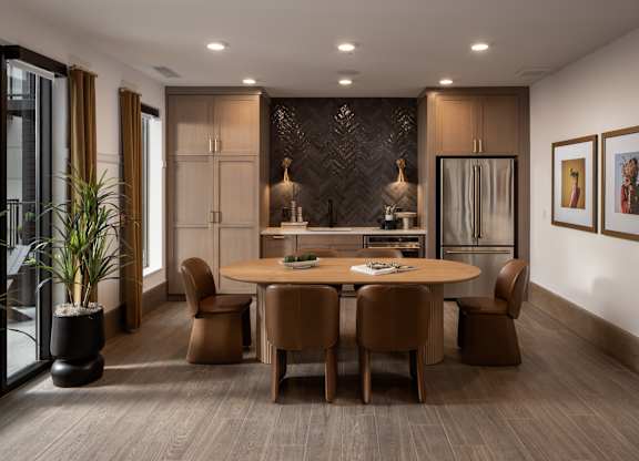 A modern dining room with a wooden table and chairs.