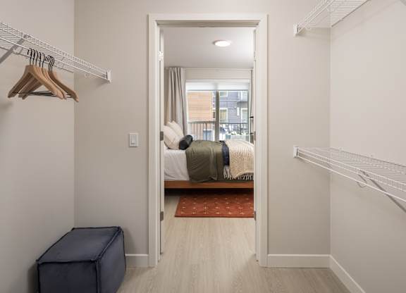 A bedroom with a bed, a wardrobe, and a window.
