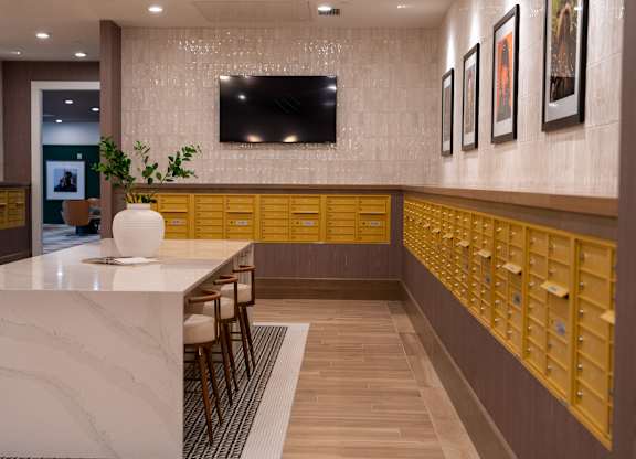 A reception area with a white counter and a row of mailboxes.