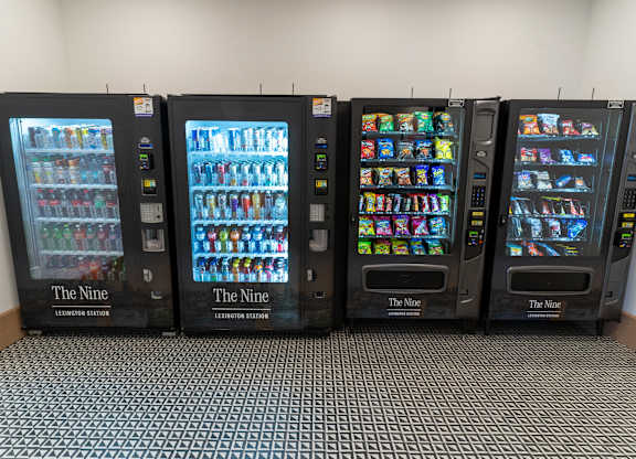 Four vending machines are lined up in a row.