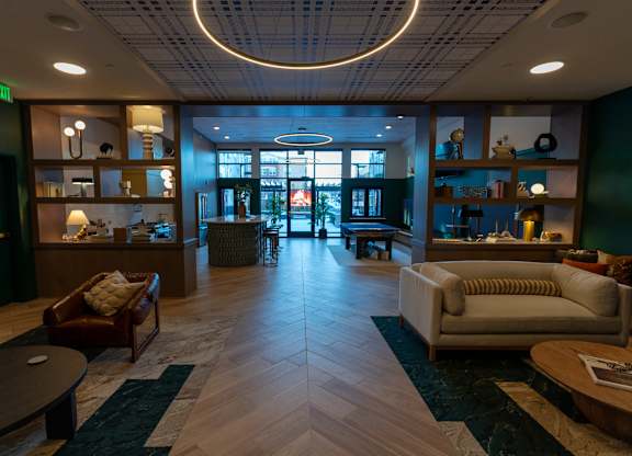 A spacious waiting room with a variety of seating options and a large window.