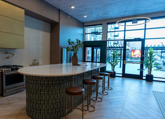 A modern kitchen with a bar stool.