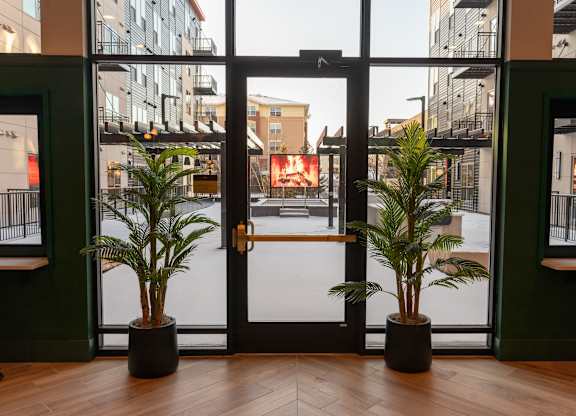 A glass door with a black handle is the main focus of the image.