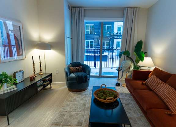 A living room with a brown couch and a blue coffee table.