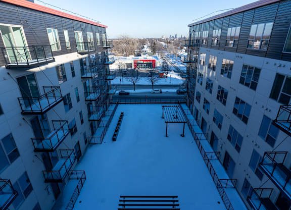 A view of a courtyard from a high angle with buildings on either side.