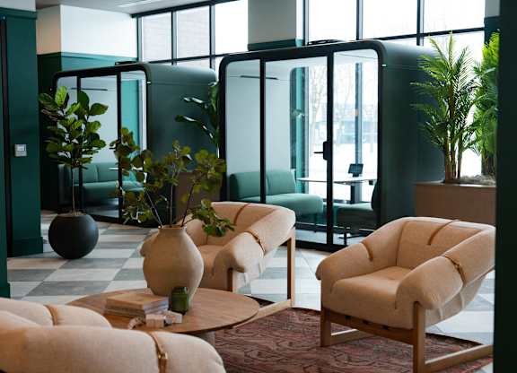 A living room with a green wall and a large window.