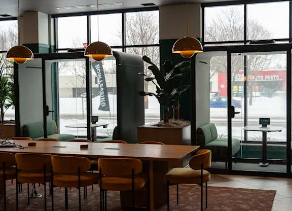 A conference room with a long table and chairs.