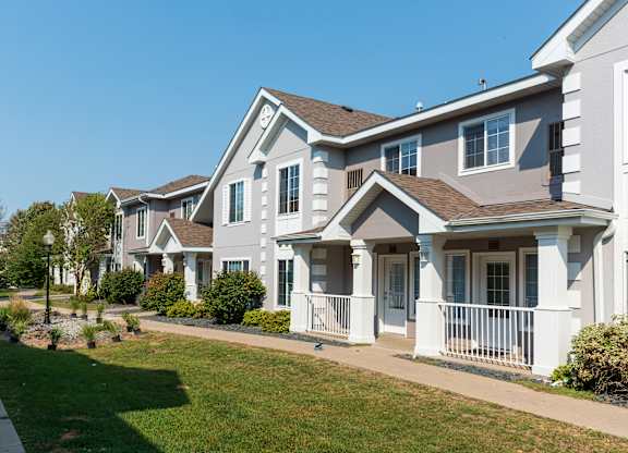 A row of houses with white and grey exteriors.
