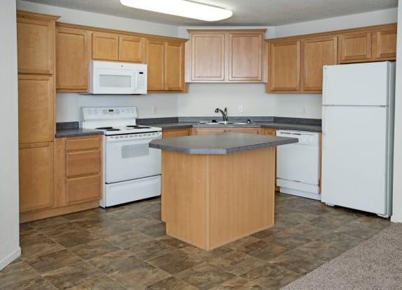 a kitchen with white appliances and wooden cabinets