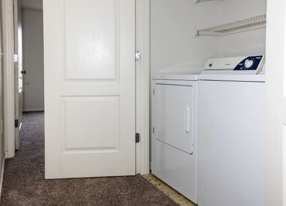 a room with a refrigerator and a washer and dryer