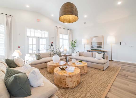A living room with a white couch and a wooden coffee table.