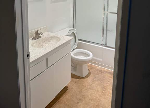 A white sink and toilet in a bathroom.
