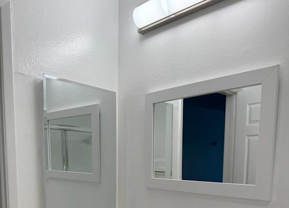 A bathroom with a sink and mirror.
