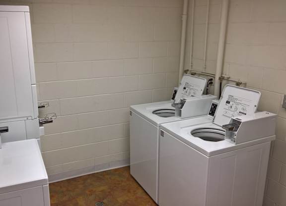 A white washing machine and dryer in a small room.
