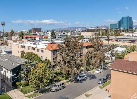 A view of a residential area with houses and cars.