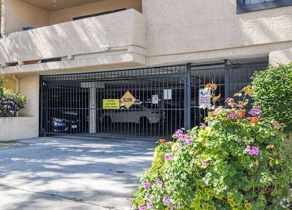 A yellow sign on a gate that says "SLOW".
