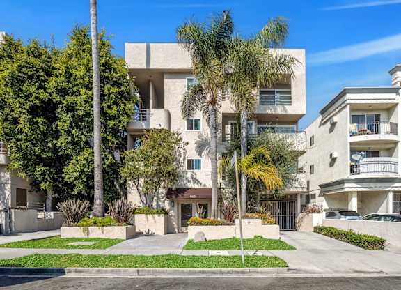 Image of the 9025 Alcott Apartment building with a well-maintained lawn and trees.