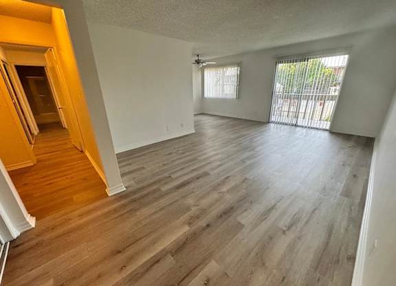 A room with wooden flooring and white walls.