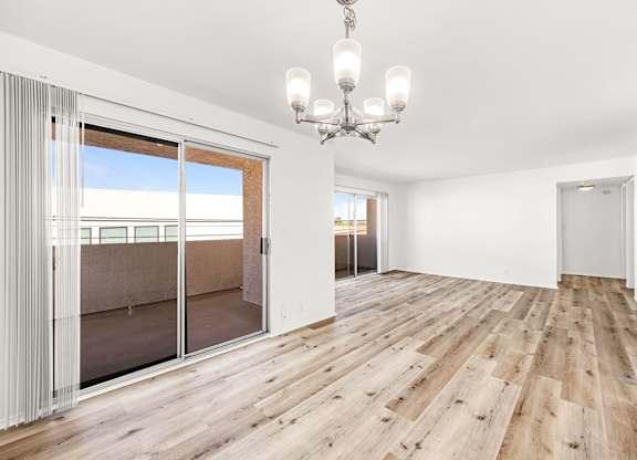 A room with wooden floors and a chandelier.