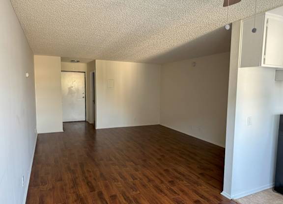 A room with wooden floors and white walls.