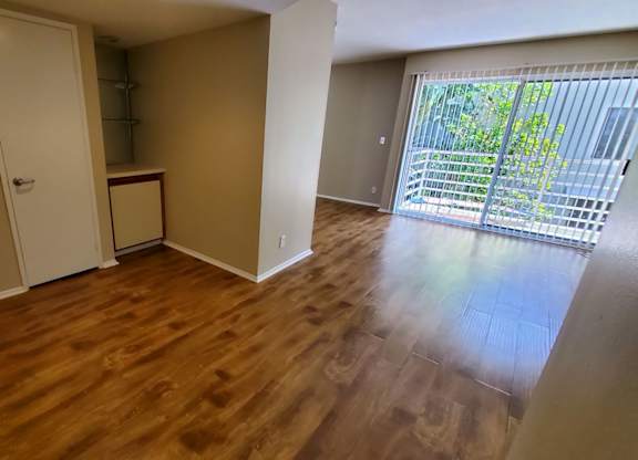 A room with wooden floors and a white door.