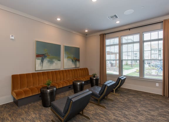a room with a couch chairs and paintings on the wall at The Whitworth, Williamsburg, VA, 23185