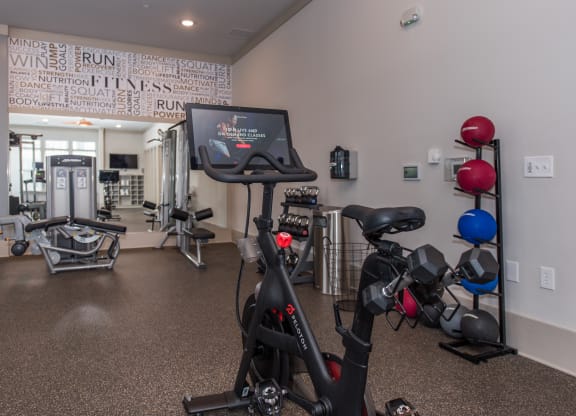 a spacious exercise room with cardio equipment and a treadmill at The Whitworth, Virginia, 23185