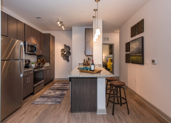 a kitchen with a large island and stainless steel appliances at The Whitworth, Williamsburg, VA, 23185