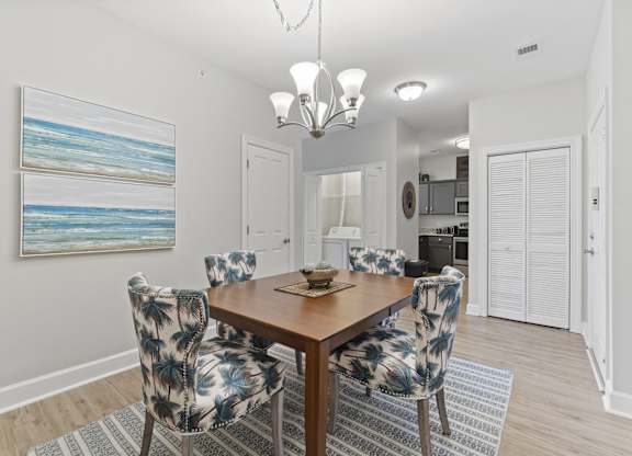 A dining room with a wooden table and chairs with a blue and white pattern.