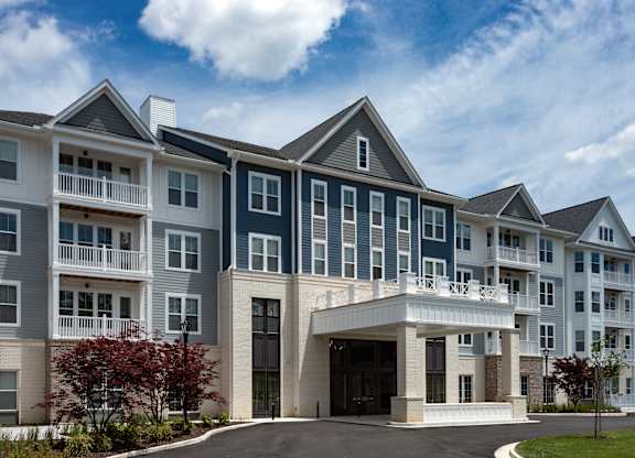 A large building with a white entrance and balconies.
